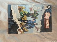 Cover of The Question comic book showing characters in a snowy mountain scene