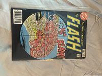 Black cover Flash comic with cross-hair and BLAM! caption in sleeve