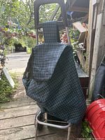 Full view of two-wheel folding shopping trolley with plaid fabric bag