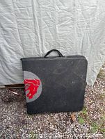 Table folded showing carry handle and logo partial