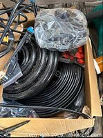Box with coiled tubing, bags of emitters and red end caps