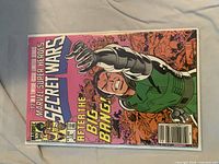 Front cover of Secret Wars #12 in bag with board