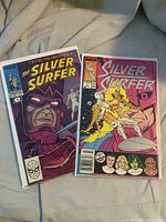 Both Silver Surfer issues side by side