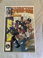 Cover of issue #129 showing Spider-Man crashing through window fighting Foreigner