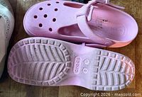 Top and sole views of pink Crocs clogs