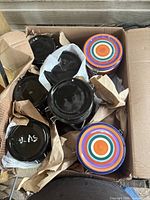 Box containing black and striped jars top view