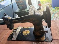 Close view of Singer treadle sewing machine head and bed