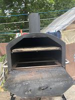 Front view showing open upper cooking chamber and lower rack