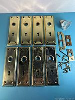 Full set: eight backplates, glass knob, three strike plates, screws