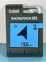 Front view powered on showing blue backlit display with directional arrow and distance