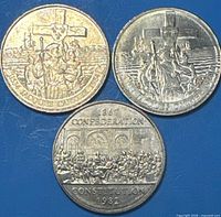 Group shot of three Canadian commemorative dollar coins showing reverse designs