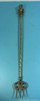 Full view of brass toasting fork showing overall length and design