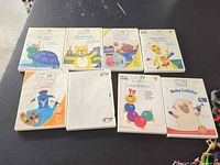 Front view of seven Baby Einstein DVD cases and one plain case