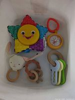 All five baby toys inside bin