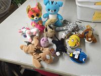 Overhead view of all twelve assorted mini plush items on table