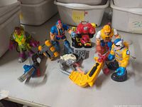 Group shot showing five action figures and accessories