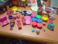 Entire lot laid out showing dolls, pets, containers, furniture and accessories