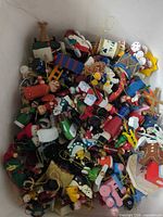 Top view of bin filled with assorted small wooden and fabric Christmas ornaments