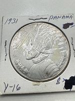 Obverse view of 1931 Panama Un Balboa silver coin in flip