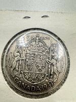 Reverse showing 50 CENTS and Canadian coat of arms, date 1943