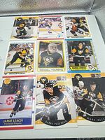 Nine hockey cards in plastic sheet, showing all players