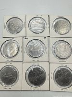 Nine Canadian dollar coins in 2×2 holders