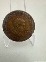 Obverse of coin showing Lindbergh bust, dates and flight legend