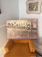 Full view of mounted photo plaque resting on chair