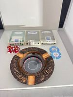 Overall lot view showing playing cards, ashtray, dice, chips