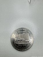 Obverse of coin showing North Bay building, floatplane, dates 1882-1982 and value