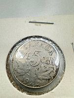 Obverse of 1924 Canada five-cent coin in holder