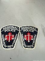 Two Hamilton-Wentworth Regional Police embroidered shoulder patches on table