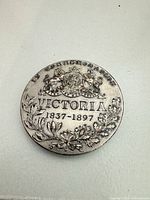 Reverse side showing coat of arms, wreath, dates 1837-1897, inscription IN COMMEMORATION