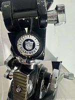Goldcrest logo and pan-tilt head detail showing paint wear