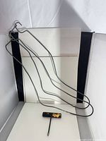 Metal wire sock drier with multiple sock-shaped frames and lace puller tool