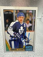 Front of Wendell Clark O-Pee-Chee card with blue ink signature
