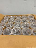 Open box showing multiple sleeves of clear plastic cups