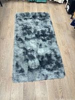 Full view of grey shaggy runner mat on wooden floor