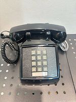 Top view of black Cortelco desk telephone showing keypad and handset