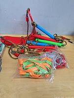 Overview of swing seat, ladder rungs, ropes, straps and hardware on table
