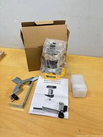 Router body, box, manual, edge guide parts, accessory case on table