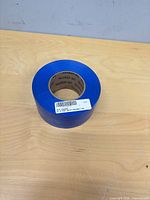 Full view of blue heat shrink tape roll on tabletop