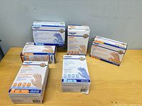 Six unopened boxes of Equate Powder-Free Exam Gloves on tabletop