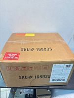 Closed shipping box showing SKU 168935 and fragile lamp shade warning