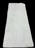 Full view of off-white rug runner showing sculpted wave pattern