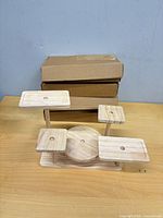 assembled wooden mini garden display stand in front of four closed boxes