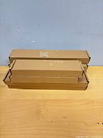 Stacked unopened cardboard boxes containing jewelry holders