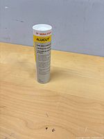 Full view of sealed Walter Alucut lubricant tube upright on table