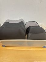 Top view showing eight black foam cushions in storage bin