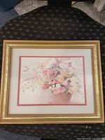 Front view of framed floral still-life print in gold frame